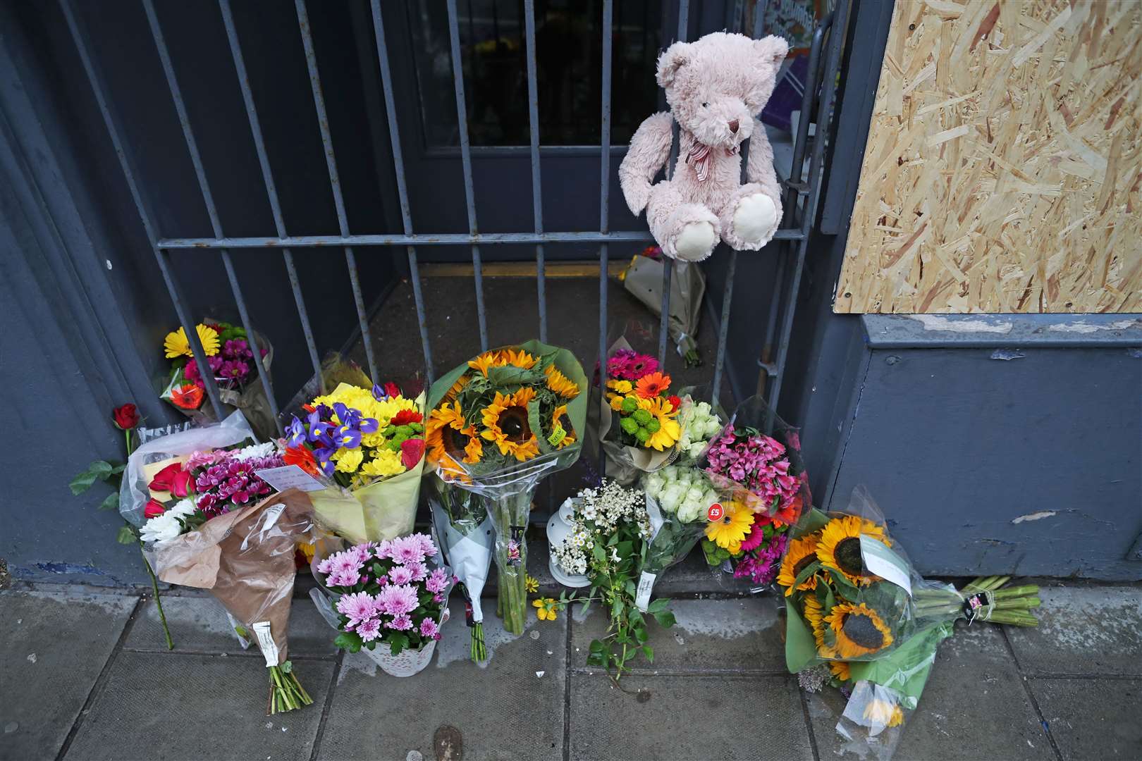 Flowers and a teddy bear were later left at the scene in tribute (Jane Barlow/PA)