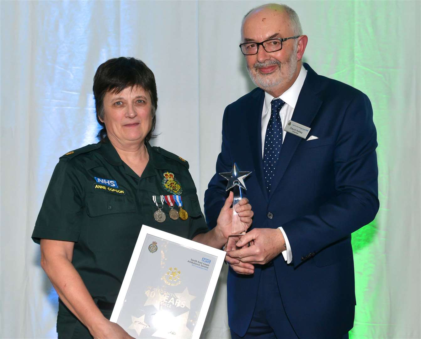 Ann Copson being handed her award for her40 years' service to ambulance service