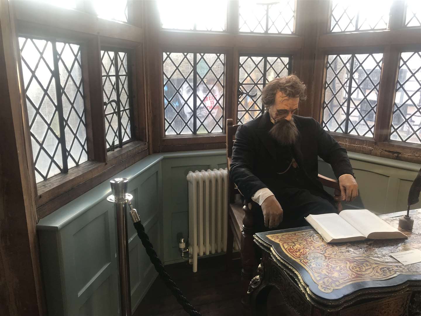 Dickens himself - or a lifelike model - takes centre stage in Eastgate House's Dickens Room, while Billy Childish's face looms in from a mural across the street