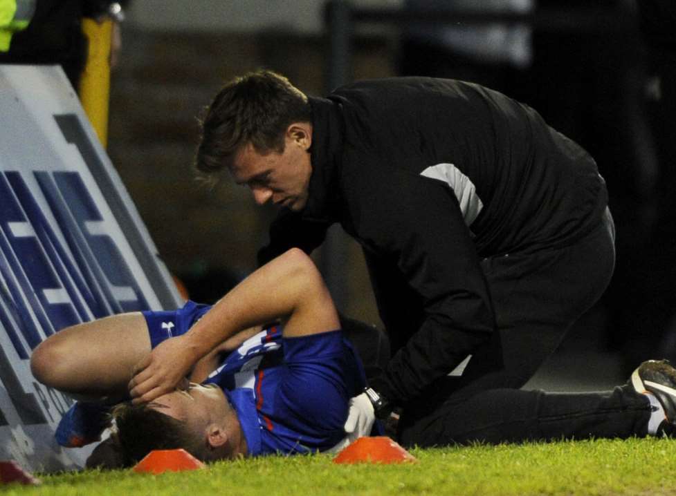Callum Emptage receives treatment after being fouled. Picture: Barry Goodwin