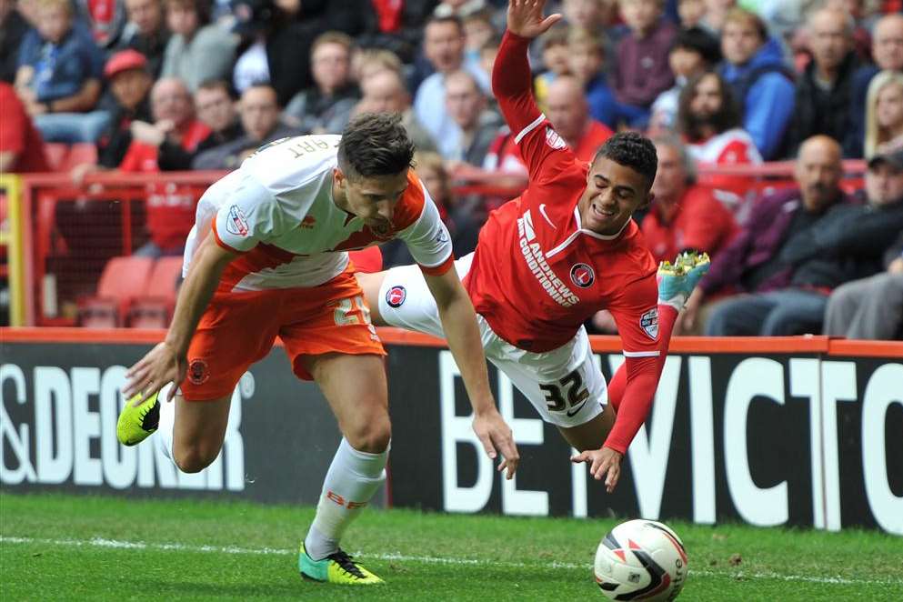 Charlton's Cameron Stuart is sent tumbling against Blackpool. Picture: Keith Gillard