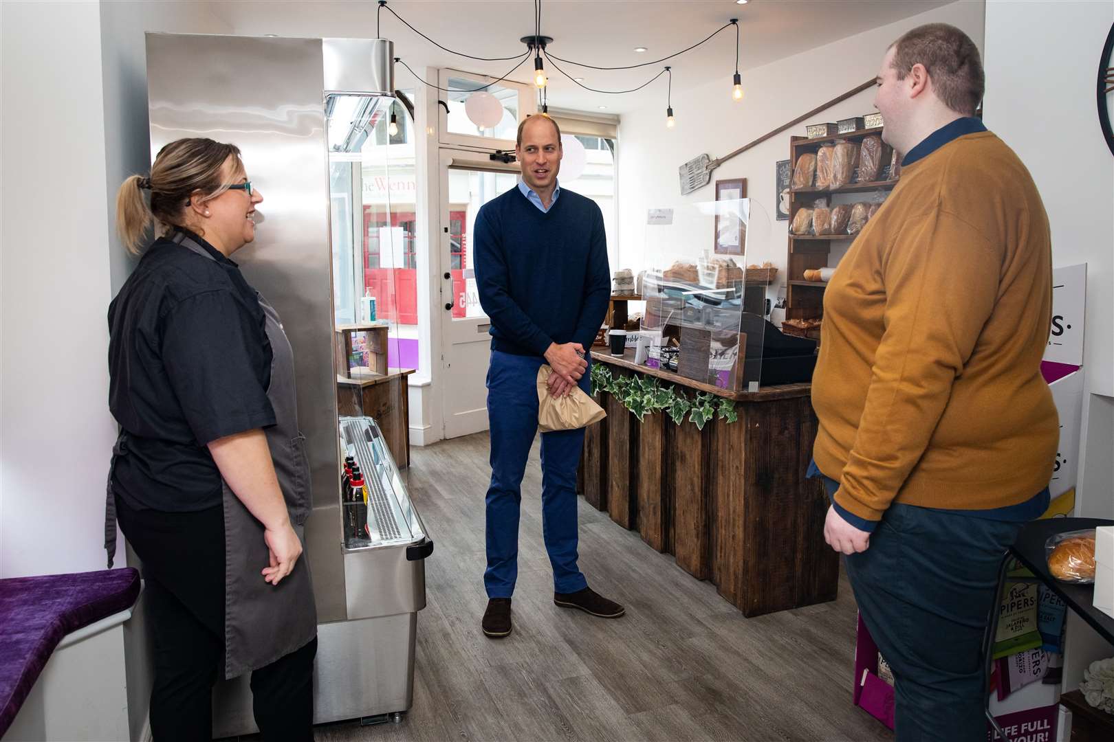 The Duke of Cambridge speaks to shop staff Sarah Easthall and Ted Bartram at Smiths Bakery (Aaron Chown/PA)