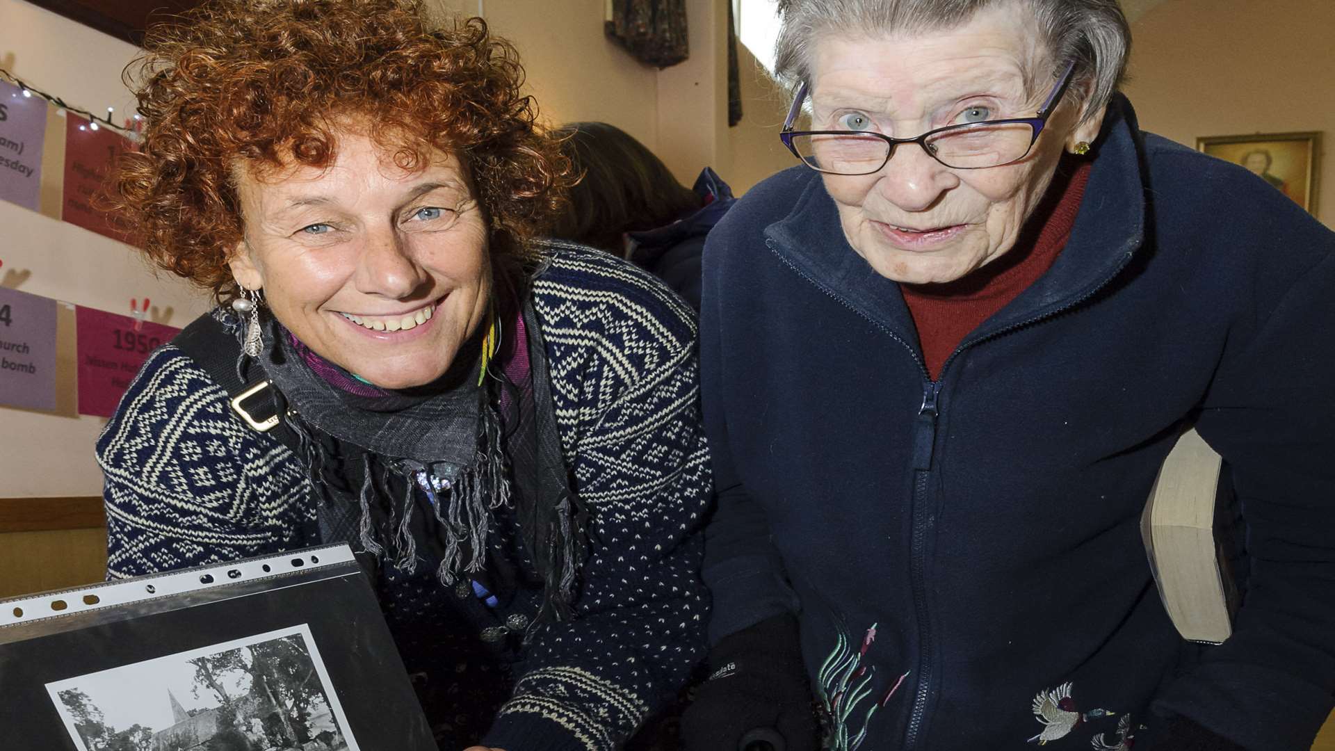 Fiona Spirals, left, and Betty Weller, looking at old photographs of Higham. Picture: Andy Payton