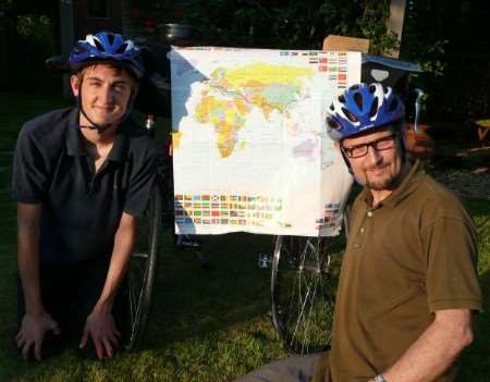 Sam and Mark Swain with the amp showing their 11,500 mile cycle route to Japan
