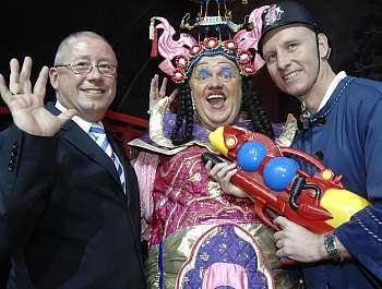 HANDS UP: Gillingham chairman Paul Scally, panto star Dave Lee and Gill's manager Mark Stimson