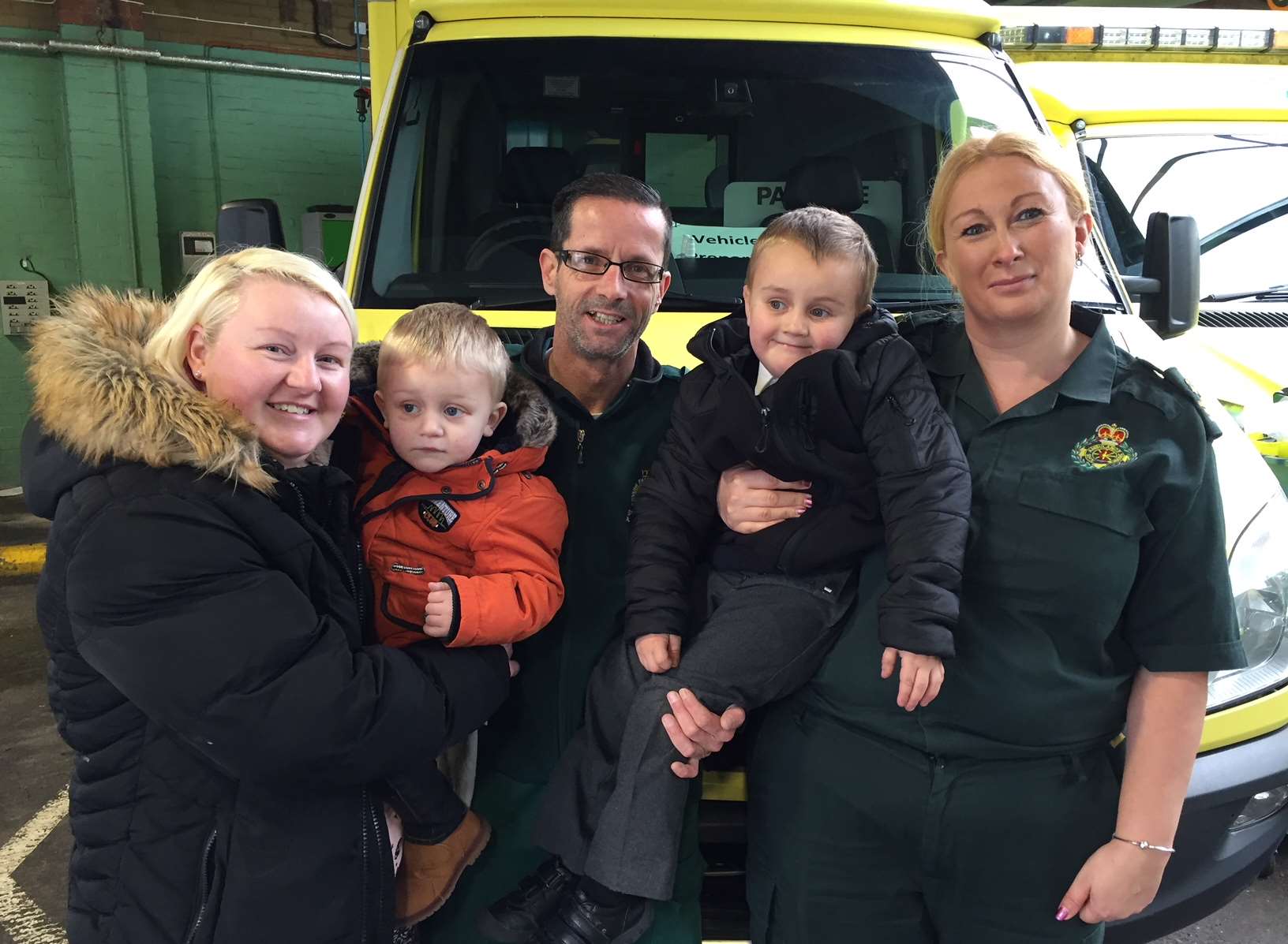 Harvey and his younger brother Louis with mum Cassandra and SECAmb's Sally Burchett and Darren Climpson.
