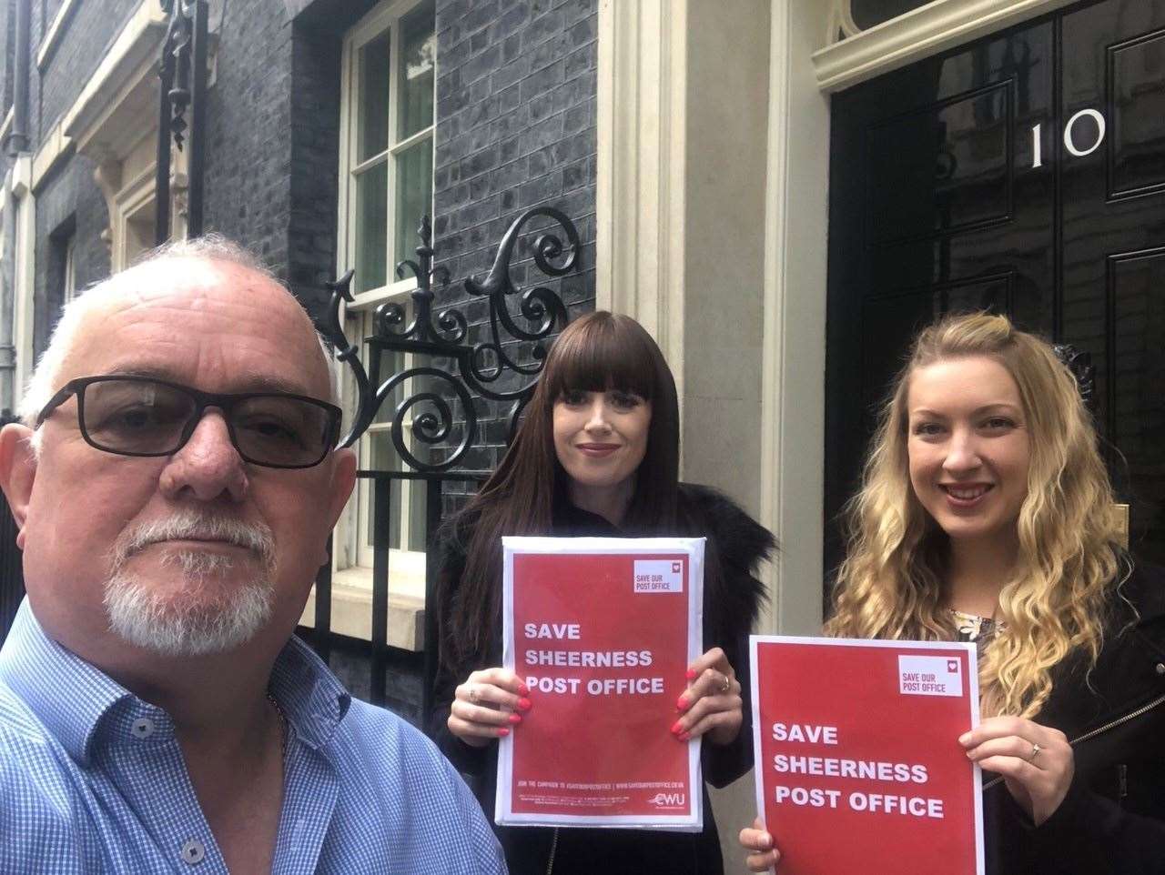 Mole Meade, of the Communications Workers Union, and Laura Steele and Stephanie Nicholls, who work in the Sheerness Post Office, handing over the petition to Number 10 (16984884)