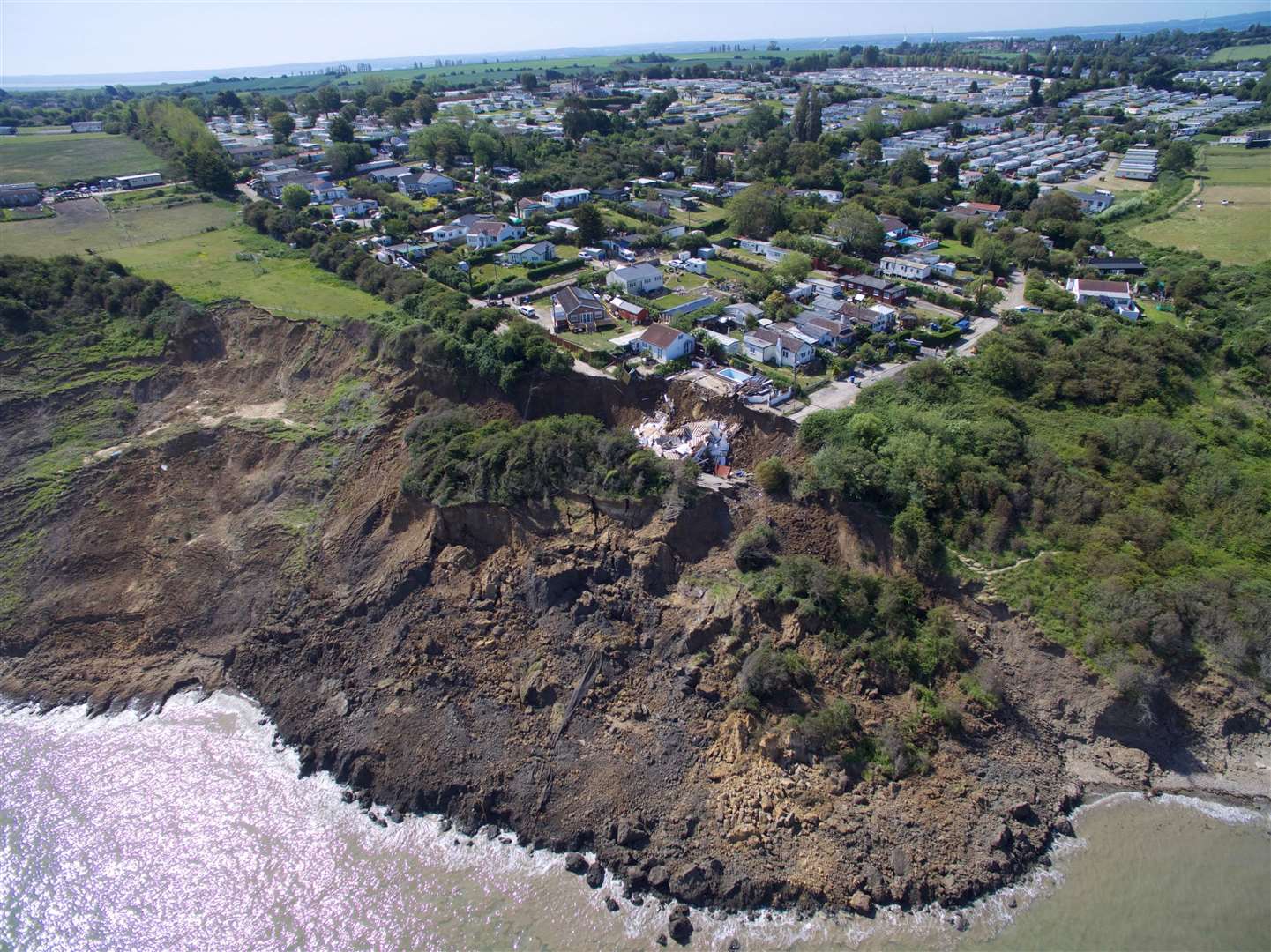An aerial image showing the house in Surf Crescent, Eastchurch, had fallen off the cliff. Picture: RLH Media