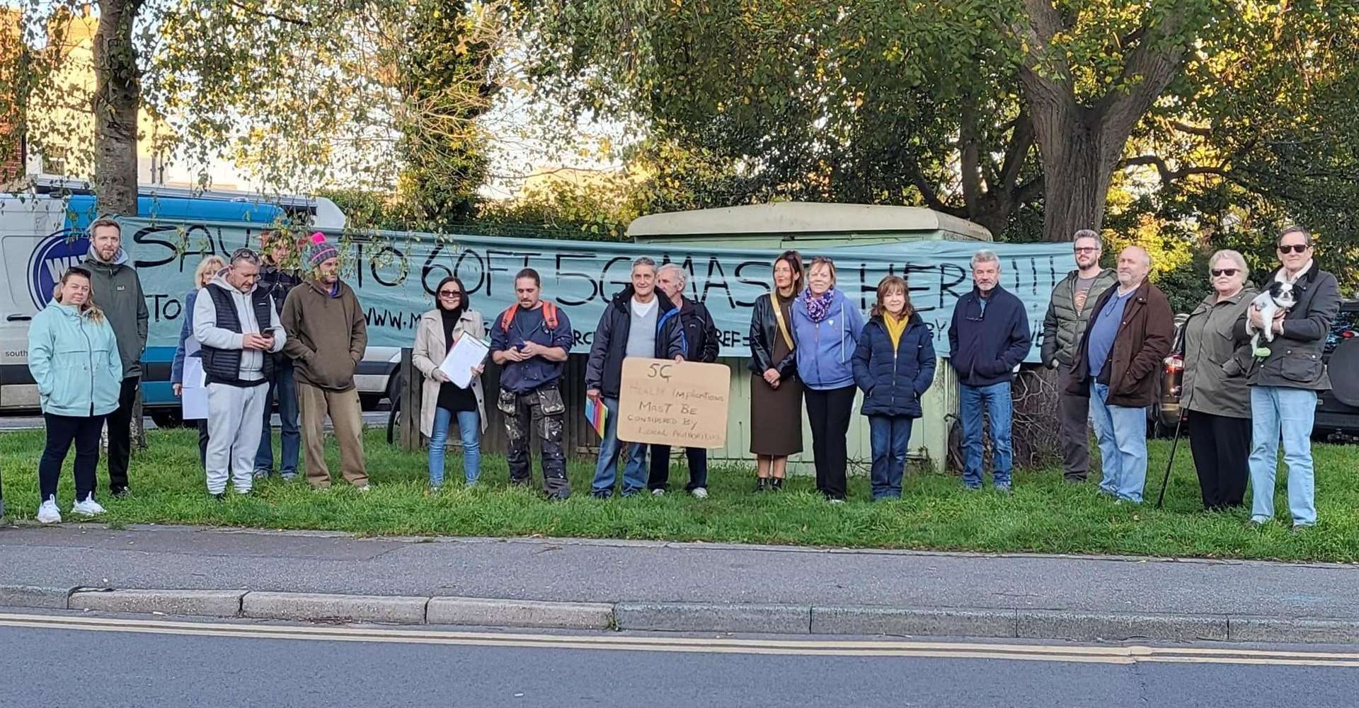 Banner-waving residents are objecting to the plans for a phone mast