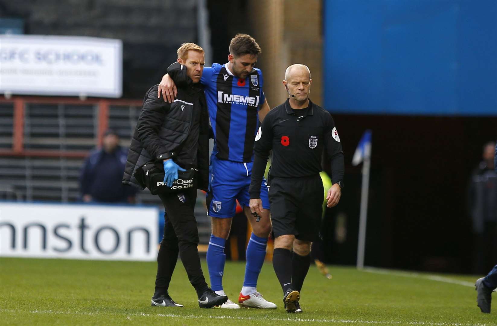 Robbie McKenzie helped from the field after being injured in a challenge Picture: Andy Jones