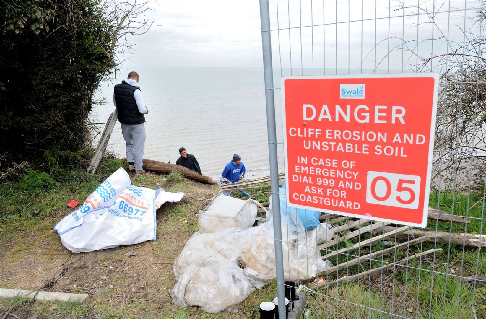 Contractors previously putting in netting to prevent cliff erosion. Picture: Simon Hildrew