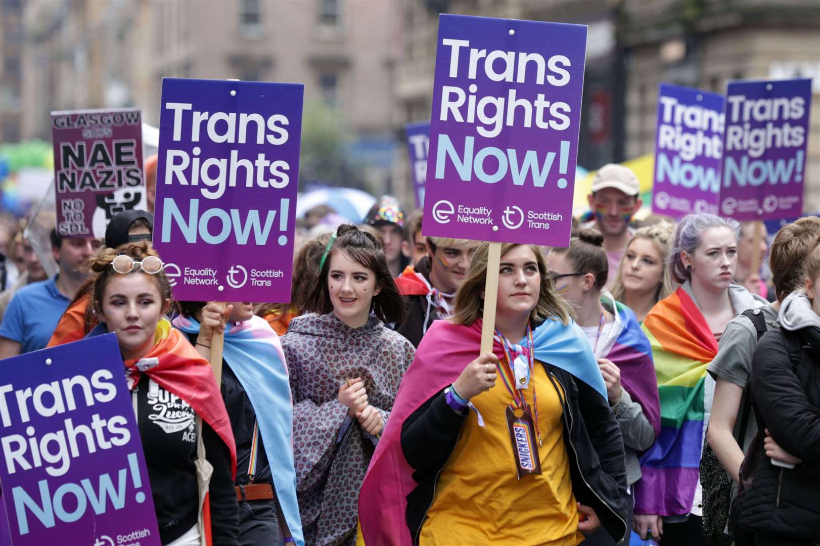 People carrying trans rights banners taking part in the Pride Glasgow parade (David Cheskin/PA)