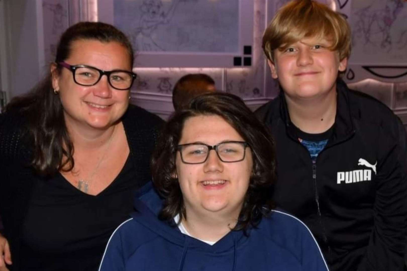 Tributes have been paid to Ethan Entwistle, pictured here (centre) with his mum and brother