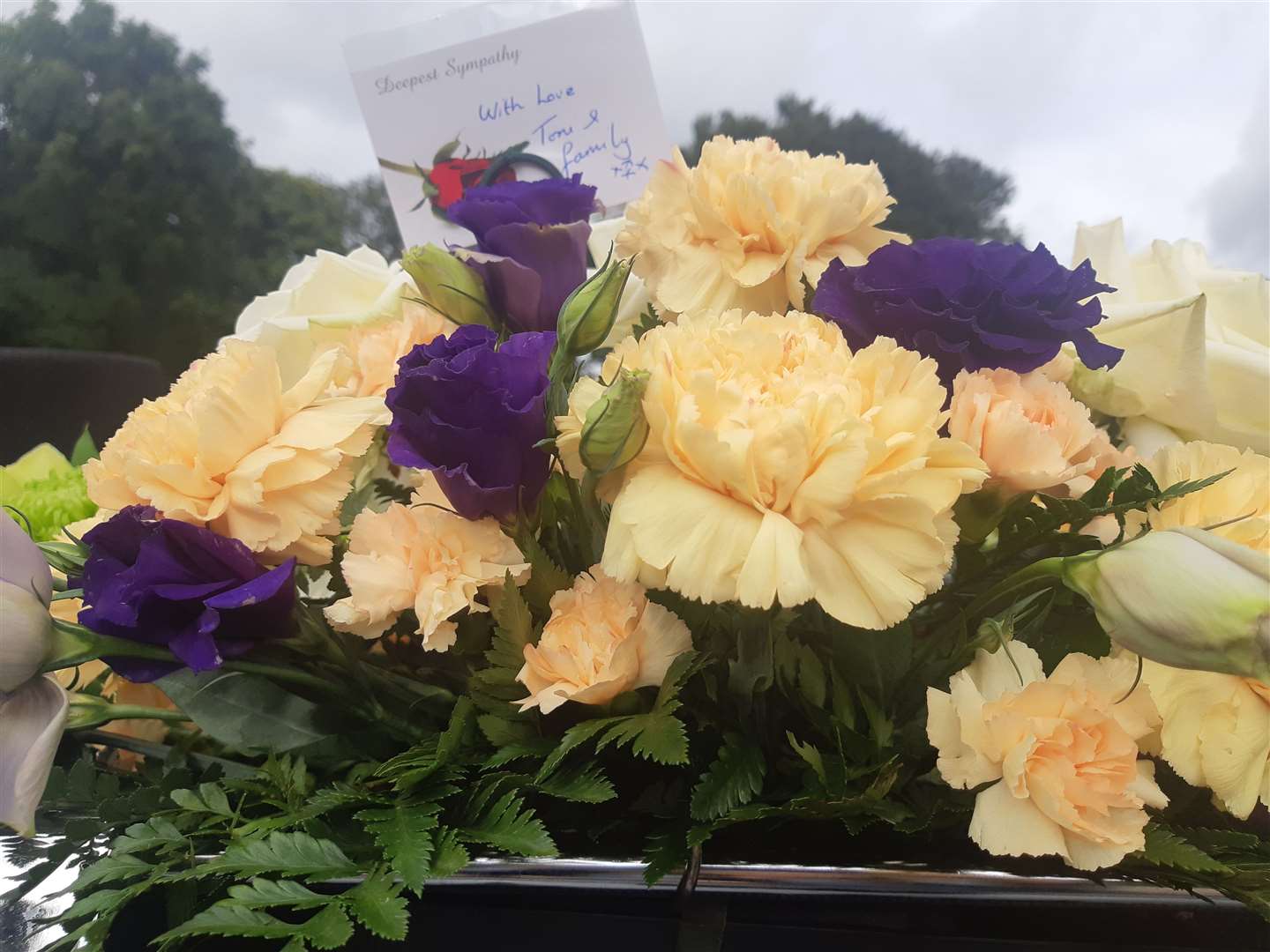 Flowers adorned the Land Rover with messages from friends and family
