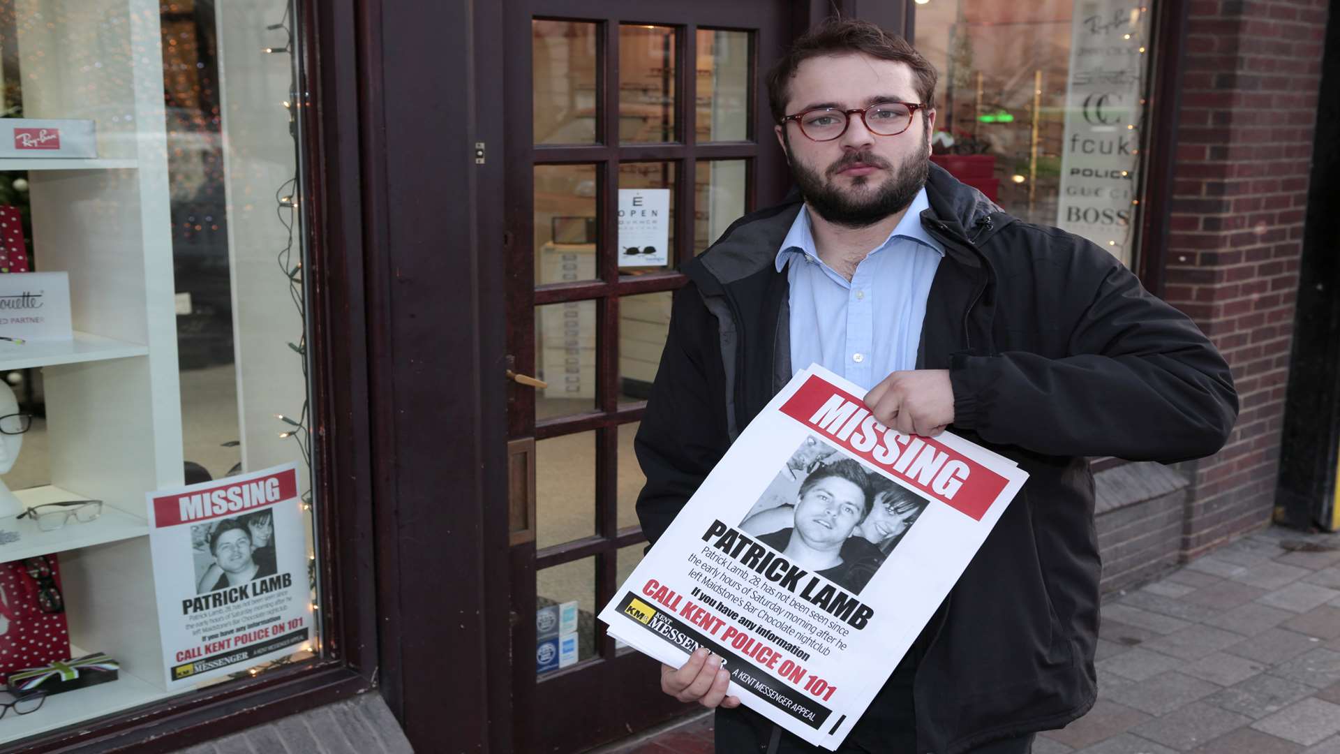 KM reporter Ed McConnell hands out posters to local businesses as part of the search to find Pat Lamb