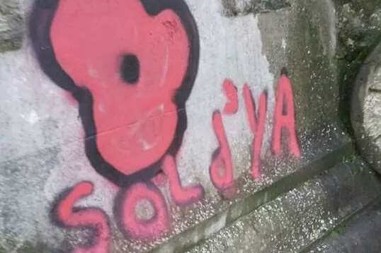 The vandal sprayed the poppy logo and the tag SOLD'YA