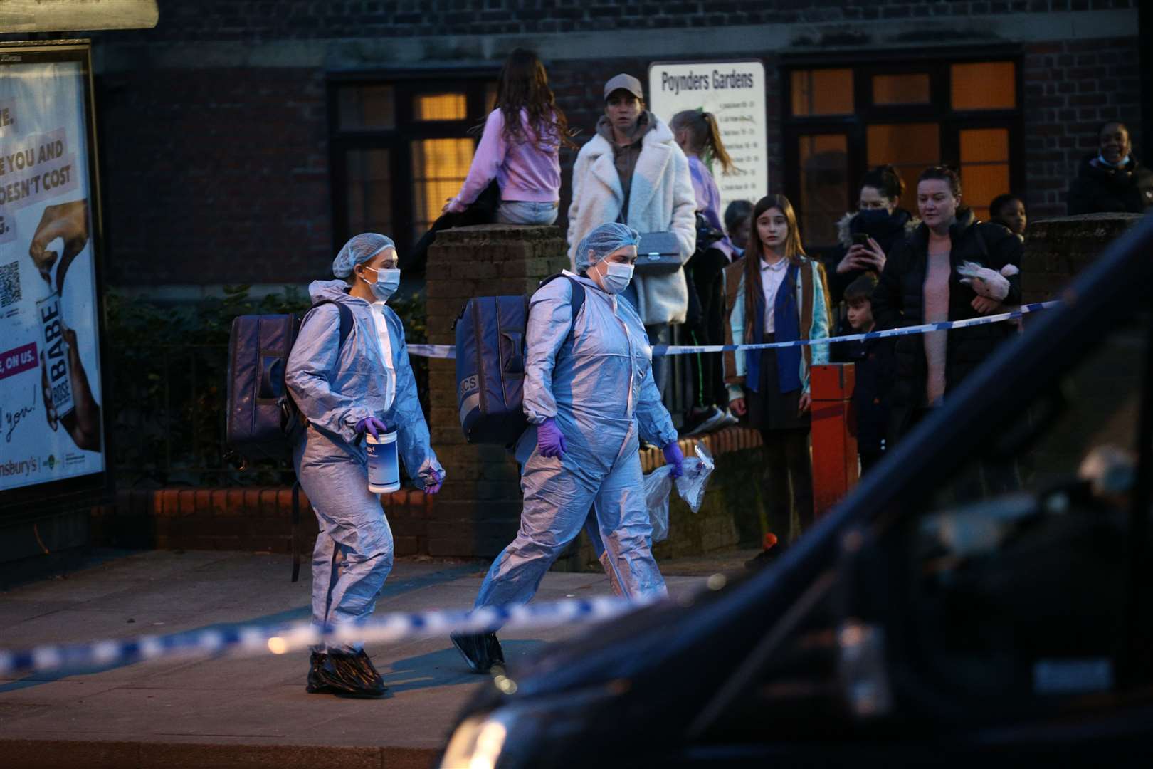 Forensics officers outside Poynders Court on the A205 in Clapham (Yui Mok/PA)
