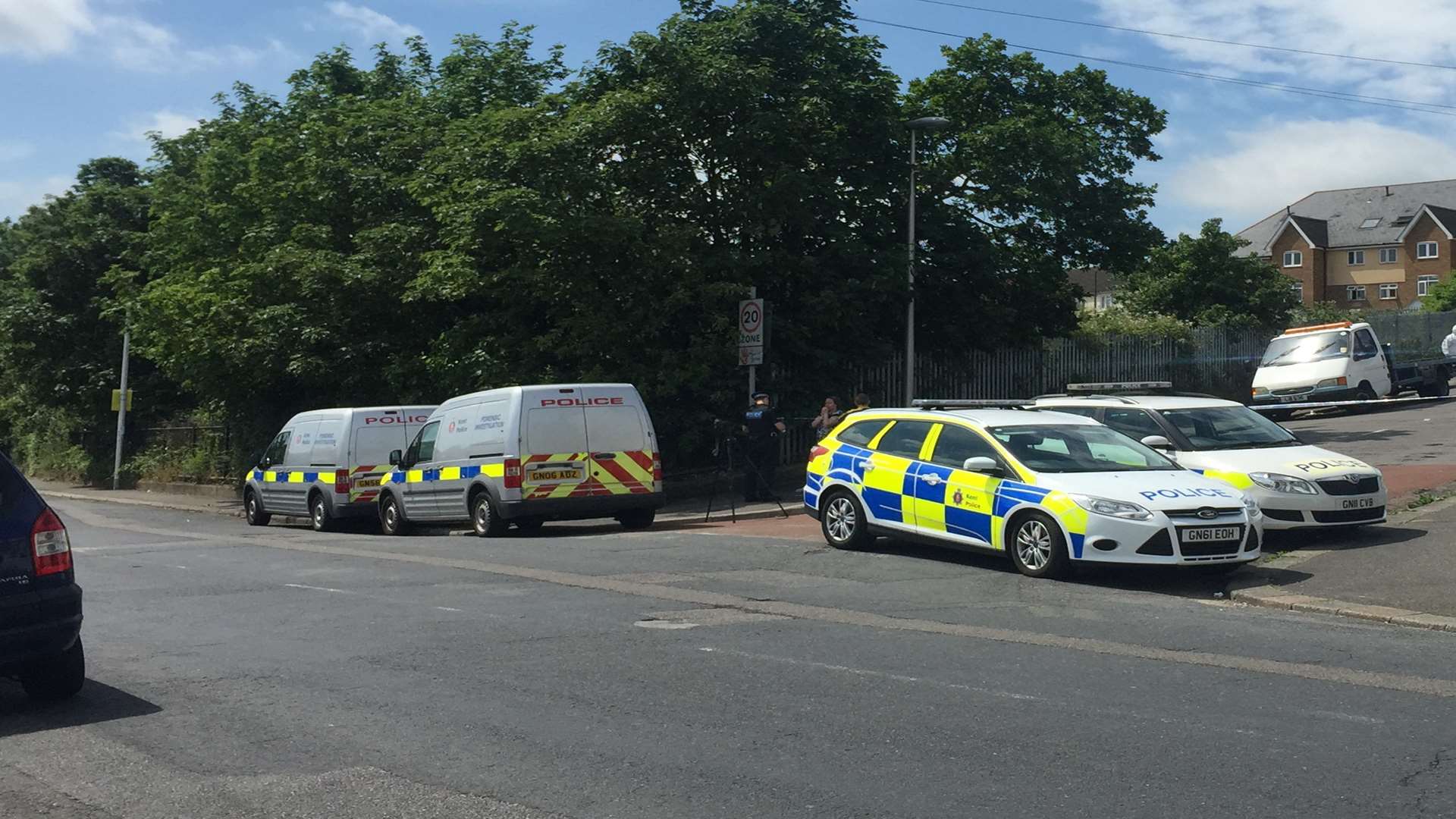 Police vehicles near the scene of the crime