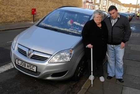 Philip Charles and his mother by the car that was vandalised