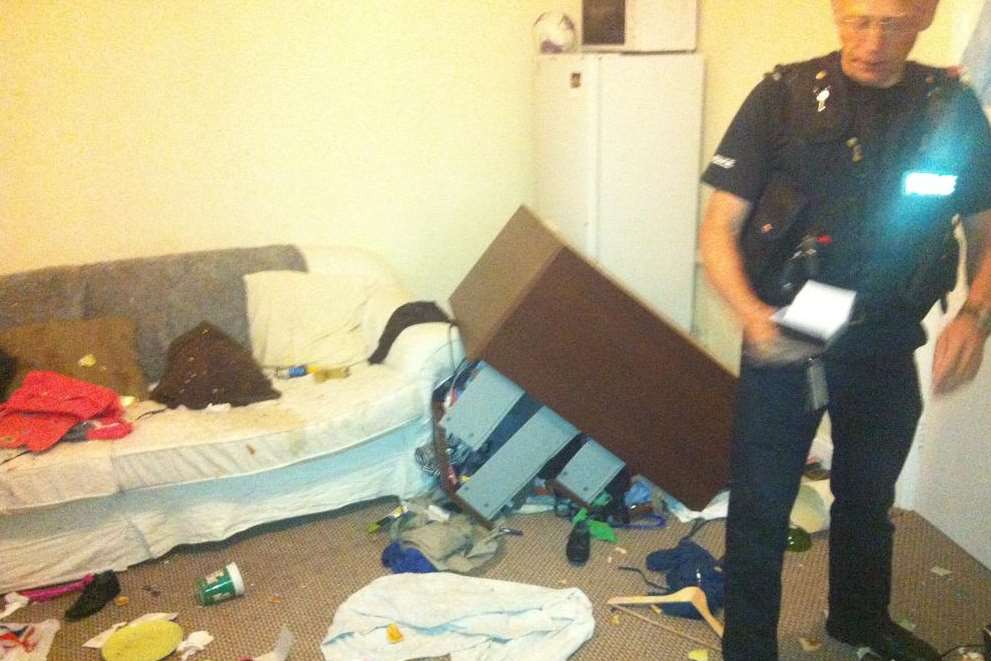 A police officer surveys the damage in Rebecca Shaw's Dover flat