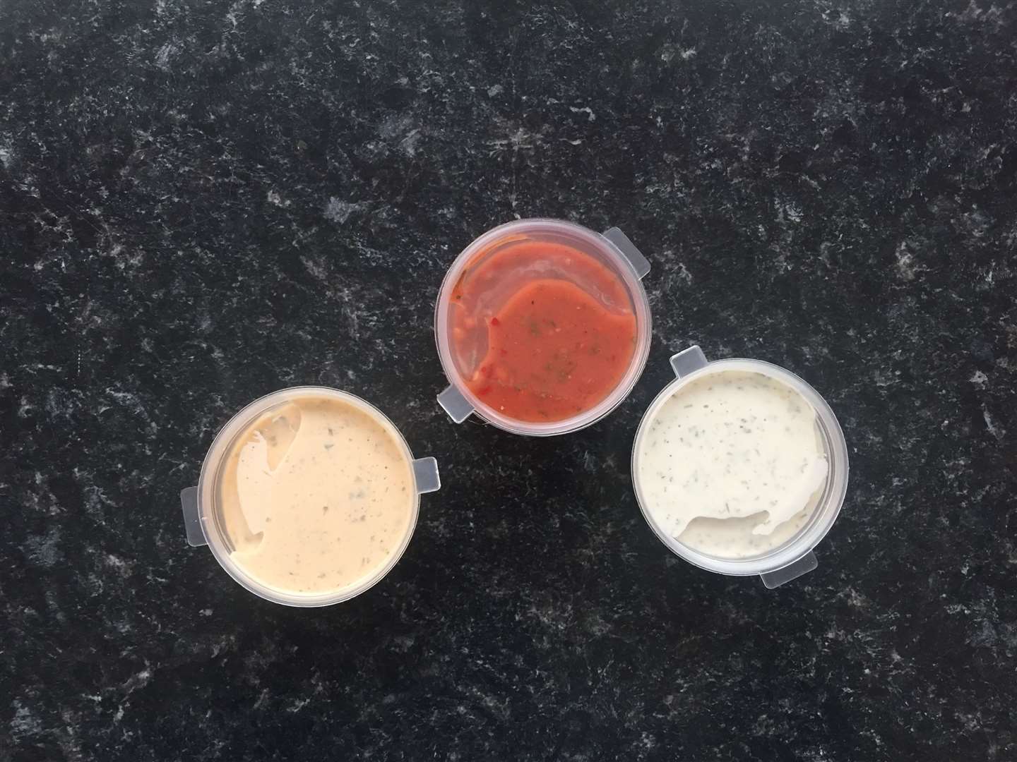 The three signature sauces: garlic, yoghurt and spicy