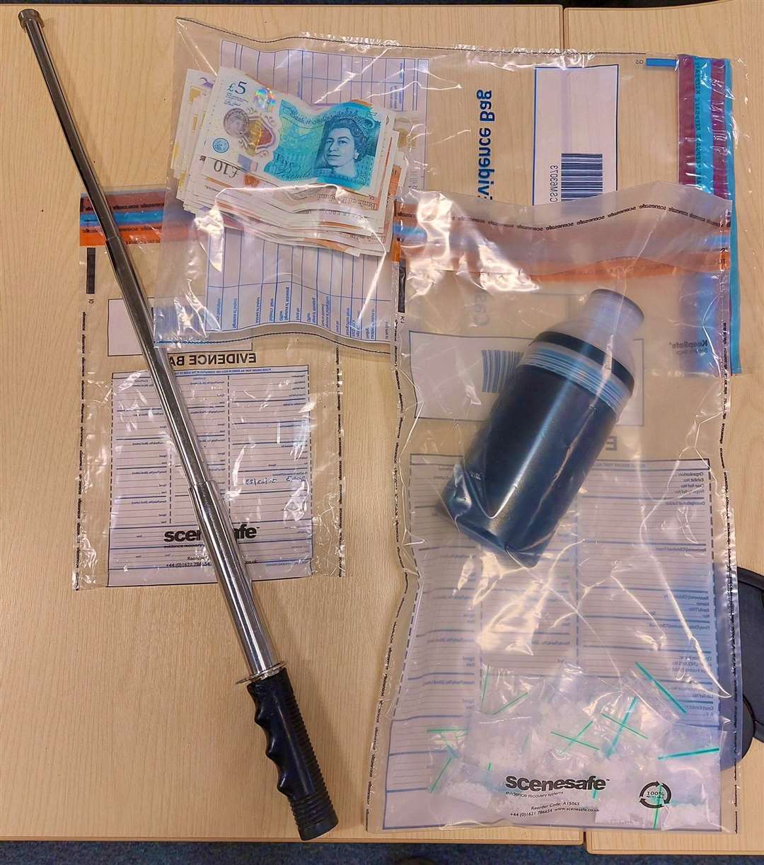 A metal baton and a plastic bottle with packets, suspected to have cocaine inside, were sezied in Chatham. Picture: Kent Police