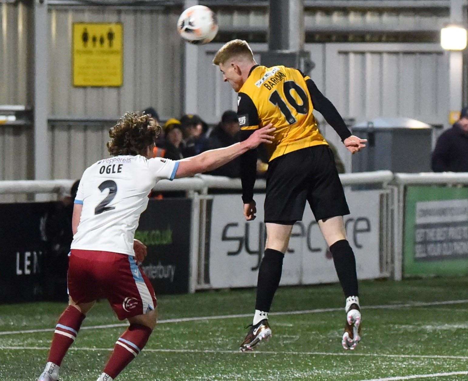 Maidstone striker Jack Barham tries to head for goal ahead of Reagen Ogle in the Stones' 1-1 draw on Tuesday night. Picture: Steve Terrell