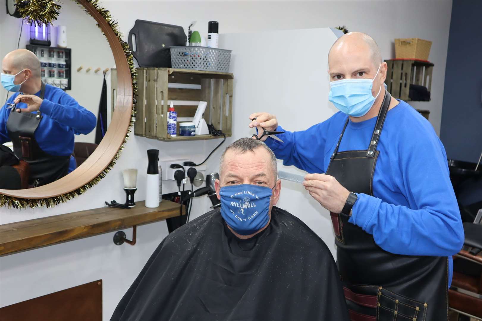 Colin Bastable of Capelli Salon in Sheerness High Street gives customer Ian Hardley a haircut after the second coronavirus lockdown