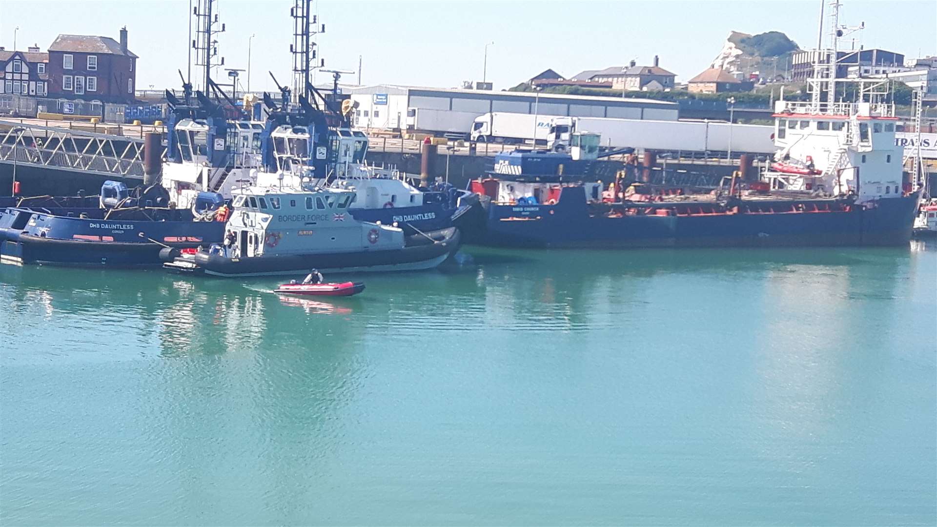 The small boat that carried the migrants from France is driven away and it will be stored