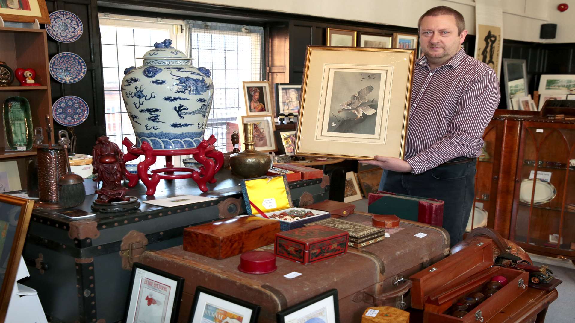 Antique dealer Jason Benson with the rare print. Picture: Martin Apps