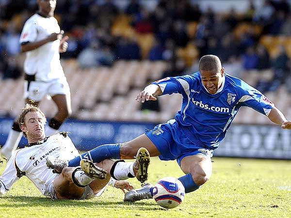 Simeon Jackson is brought down for Gillingham's penalty. Picture: MATTHEW WALKER