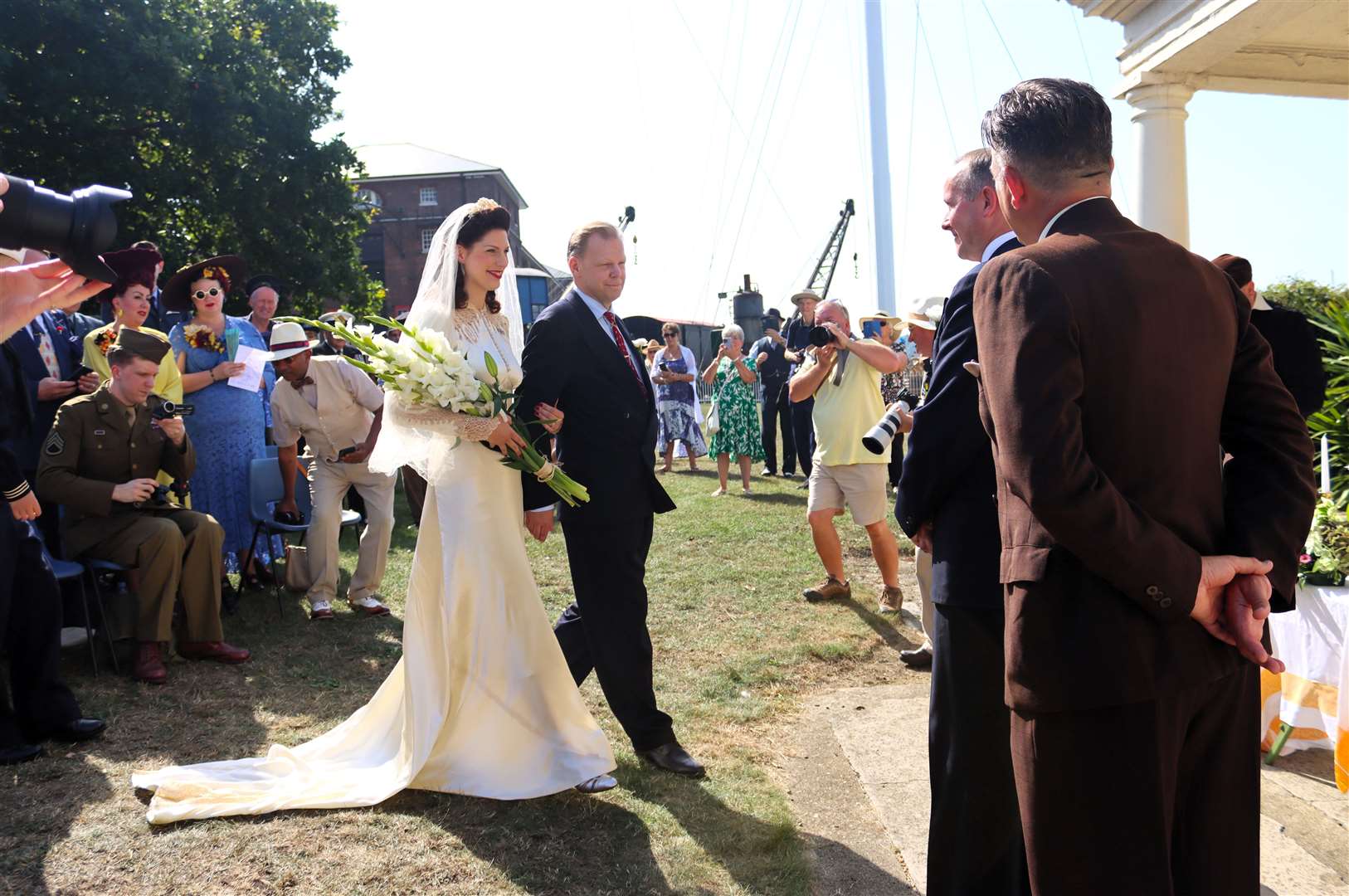 Stéphanie Cass and her father walking down the aisle at Chatham Dockyard. Picture: Rachel Evans
