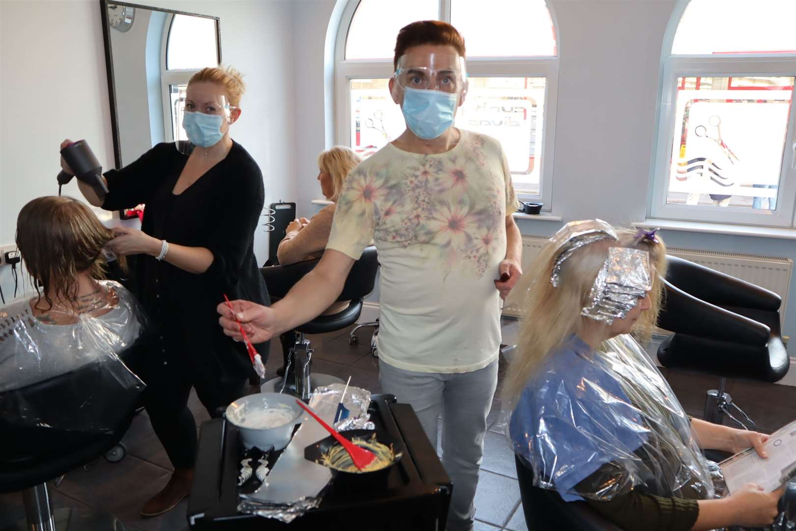 Hairdressers Kevin Nicholls and Rachel Parsons fitting in clients on the eve of the second lockdown in Sheerness