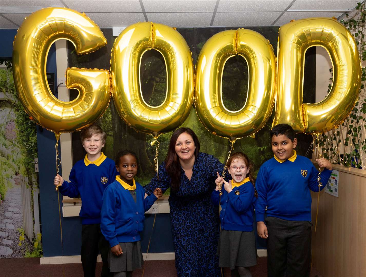The pupils of St Peter’s Catholic Primary School celebrating their Good Ofsted Inspection with Headteacher Miss Vedamuttu