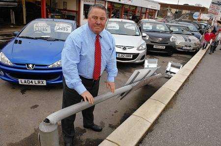 Richard Miller surveys the damage at Harbour Garage after three floodlights were pulled down by a lorry.