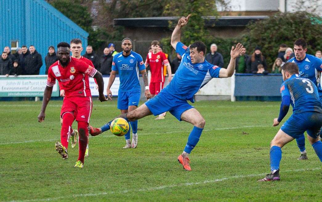Kemo Darboe fires wide for Whitstable under pressure from Herne Bay's Dan Johnson. Picture: Les Biggs
