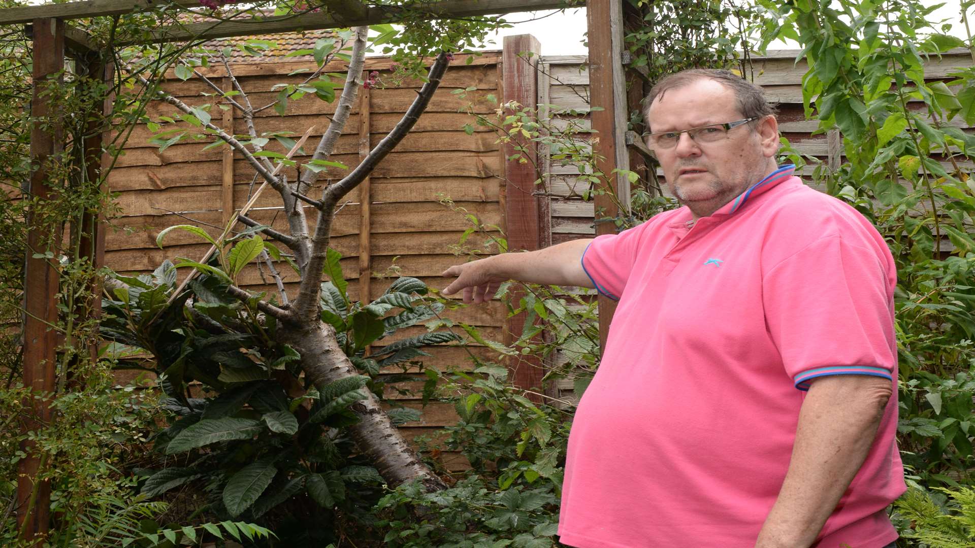 Anthony Challinger showing the damage to his garden