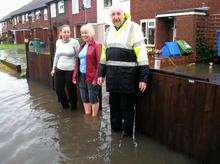 Eric Tress and his wife Carole stand outside their flooded property in Castlemere Avenue, Queenborough, along with their neighbour Shelene Mitchell.