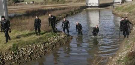 Police officers search a stretch of the River Medway. Picture: PETER STILL