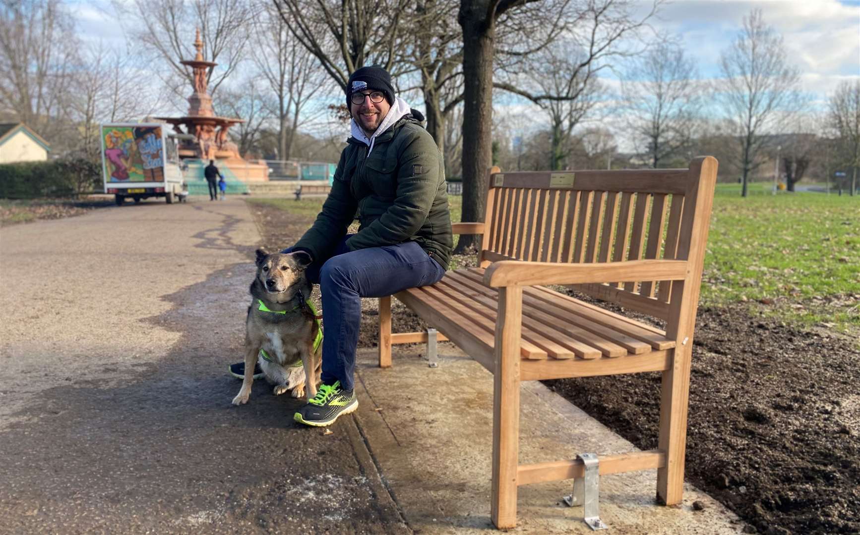 Roger Batho, Victoria Park project team leader, enjoying the new bench with his pooch. Picture: ABC