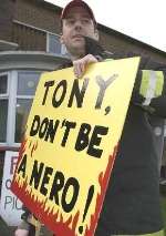 MESSAGE FOR TONY BLAIR: Firefighter Lee Davies at Medway Fire Station today. Picture: GRANT FALVEY