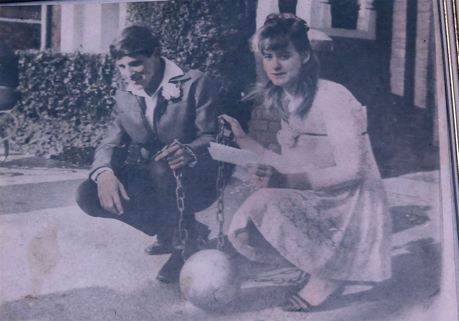 A wedding day picture shows Mr and Mrs Apps holding a ball and chain.