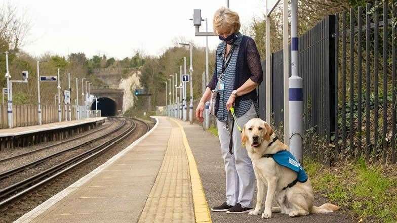 Margaret and a Guide dog waiting for a train. Picture: Margaret Mardell