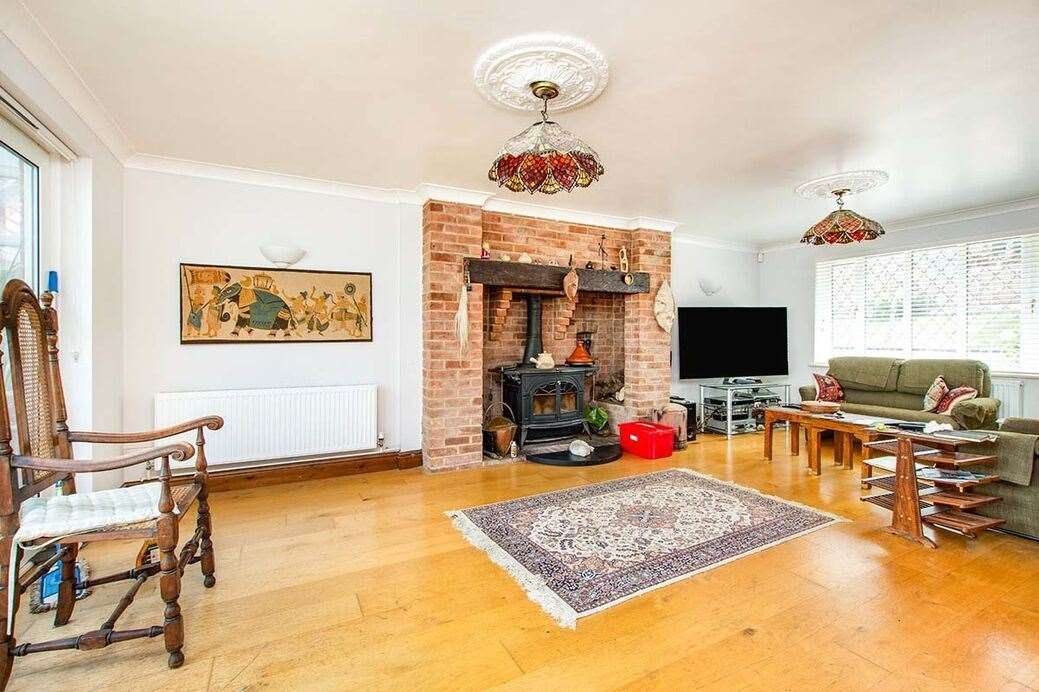 The living room has character with its brick fireplace. Picture: Your Move