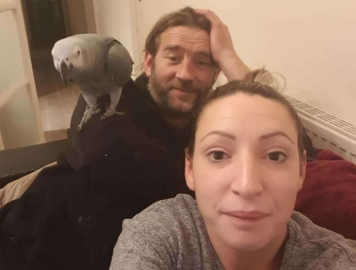 Freddie the parrot with owners Lee Foad and Elle Mier