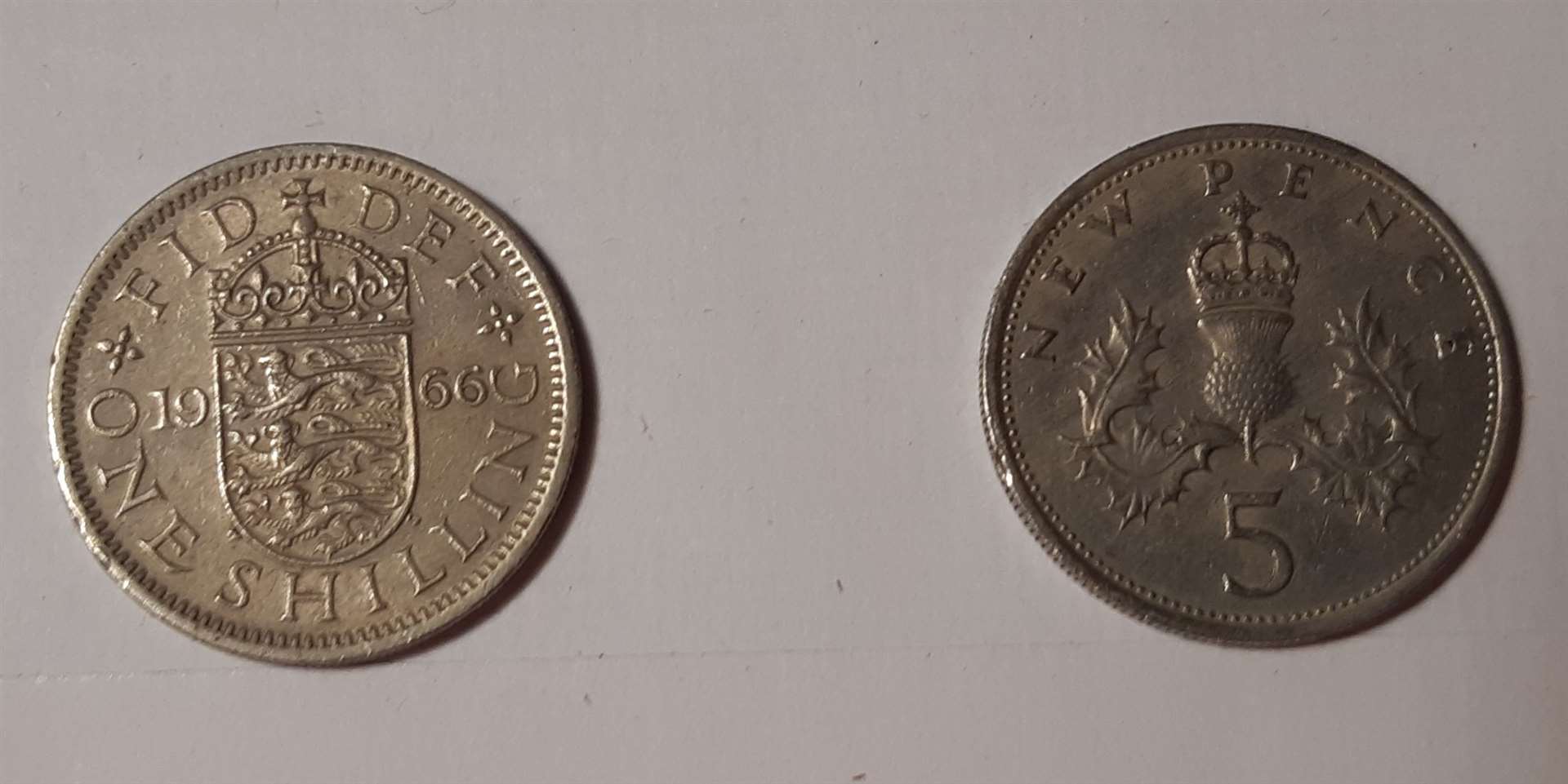A 1966 shilling and its 1968 replacement