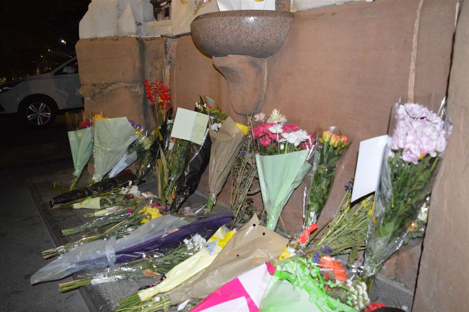 Floral tributes left to Andre Bent at the Queen's Monument in Jubilee Square following his death