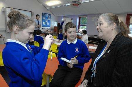 Mary Cox,11 and Louie Arthur, 10, photograph and interview teacher Miss Tracey Parker during a lesson about journalism