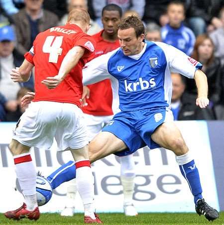 Gillingham's Mark Bentley takes on Charlton's Nicky Bailey at Priestfield