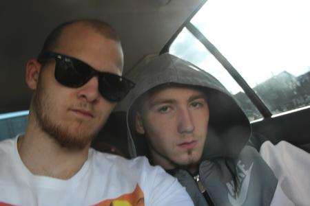 Thieves Sam Holmes and David Leadbeater pose together in a stolen car